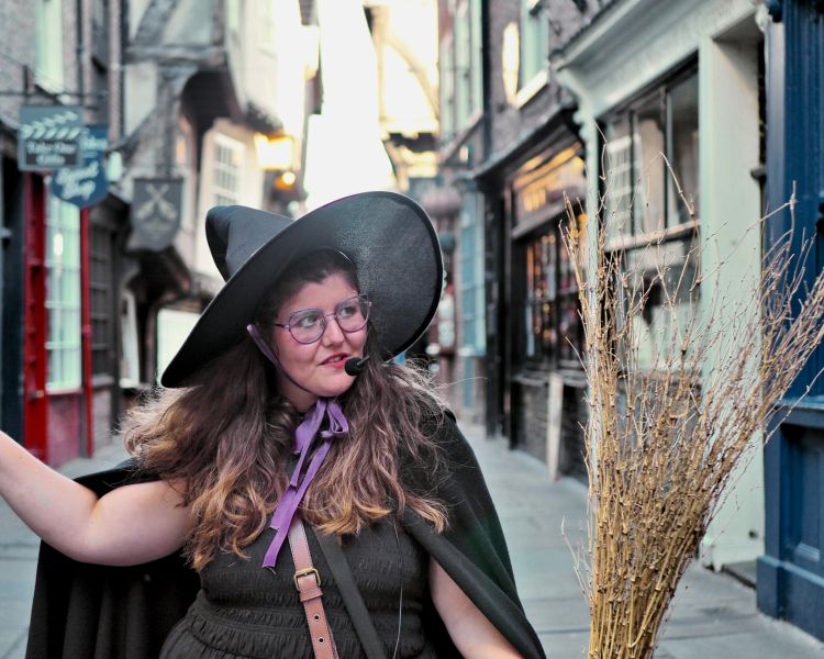 guide pointing on street on a witches walking tour in york
