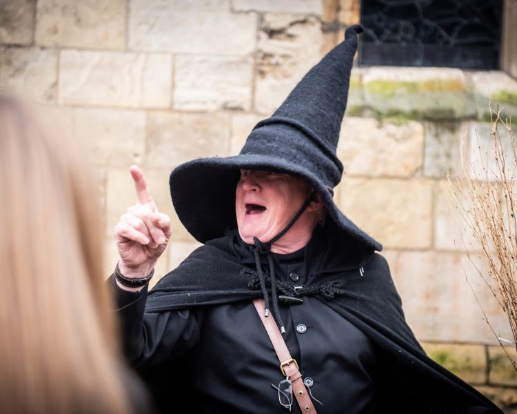 guide talking to group on a witches walking tour in york