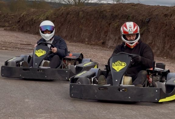 Two men in karts on drifting track