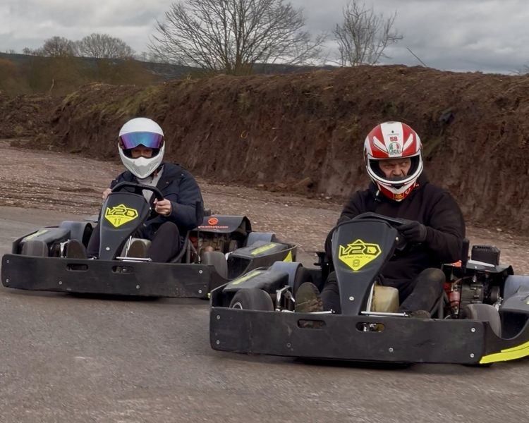 Two men in karts on drifting track