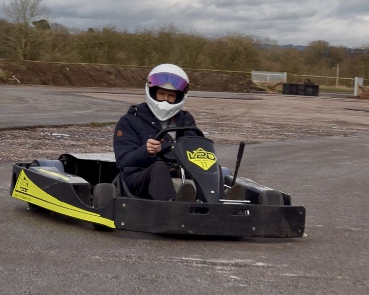 Man in kart drifting around track