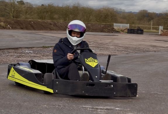 Man in kart drifting around track