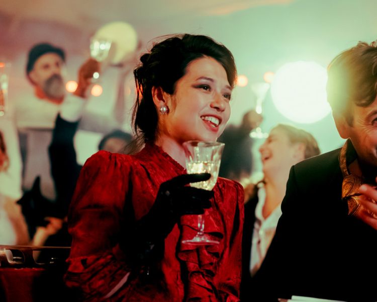 couple dressed in vintage parisian dress at the chat noir immersive dining experience in london