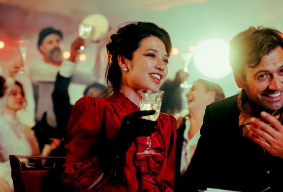 couple dressed in vintage parisian dress at the chat noir immersive dining experience in london