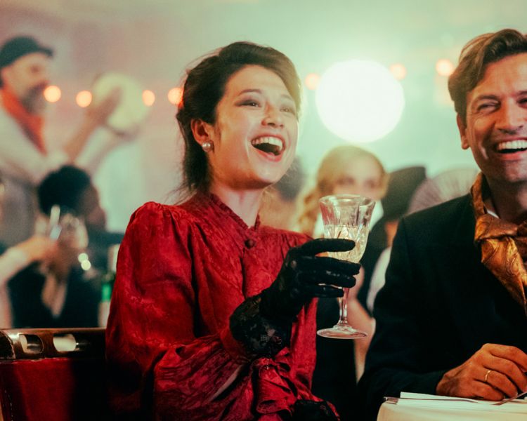 couple dressed in vintage parisian dress at the chat noir immersive dining experience in london