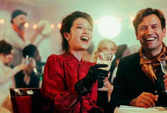 couple dressed in vintage parisian dress at the chat noir immersive dining experience in london