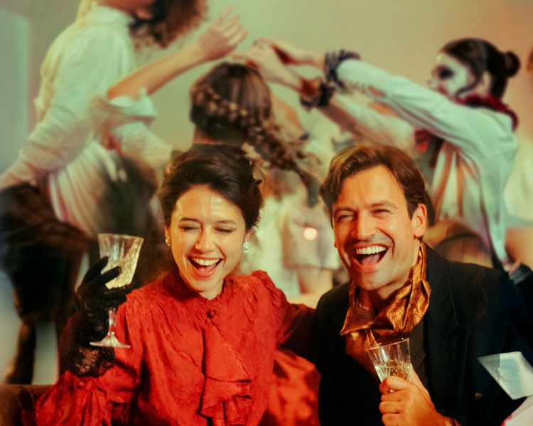couple dressed in vintage parisian dress at the chat noir immersive dining experience in london