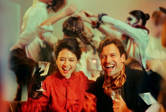 couple dressed in vintage parisian dress at the chat noir immersive dining experience in london