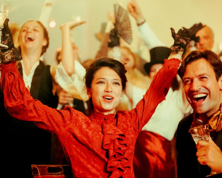 couple dressed in vintage parisian dress at the chat noir immersive dining experience in london