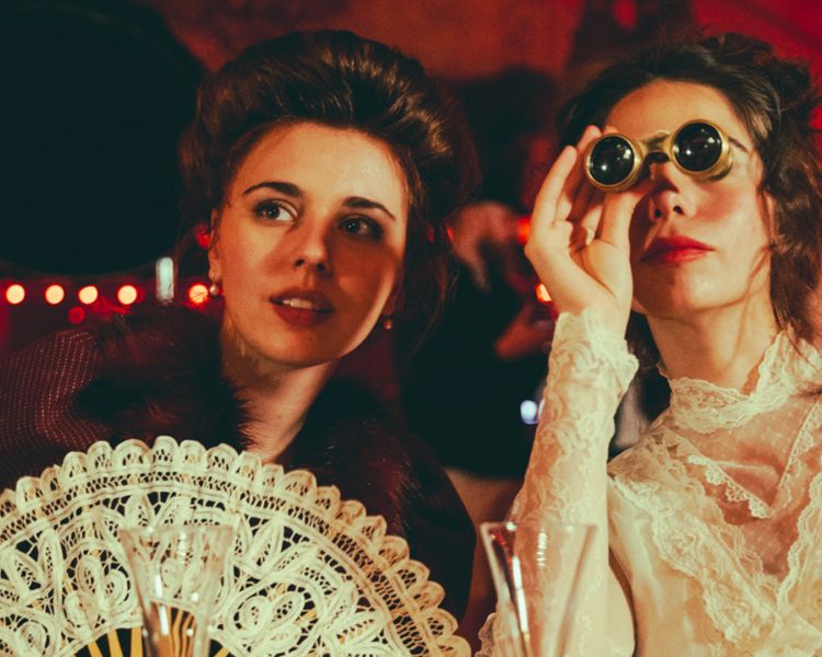 two ladies watching the chat noir immersive show experience in london