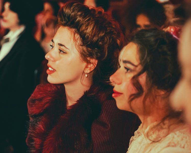 ladies in the audience watching the chat noir immersive dining experience in london