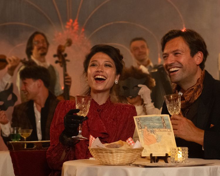 couple at table laughing at chat noir immersive dining experience in london