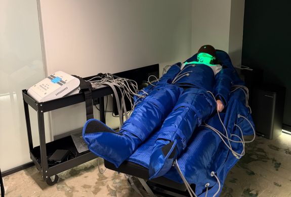Woman having lymphatic drainage treatment wearing full body suit at thriyv clinic