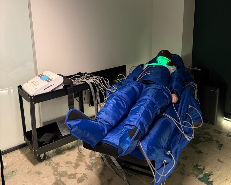 Woman having lymphatic drainage treatment wearing full body suit at thriyv clinic