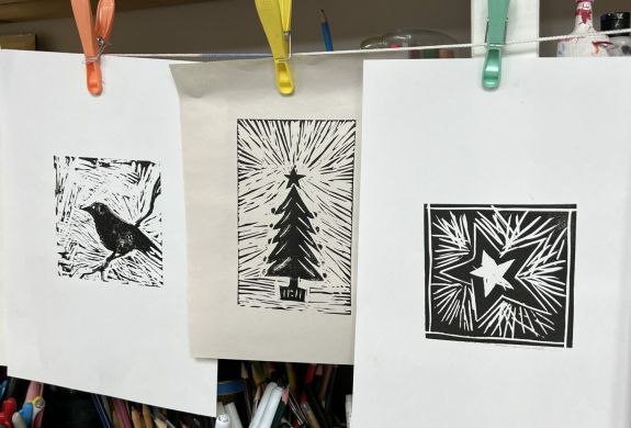 printed lino cut images hanging to dry made on a lino printing workshop