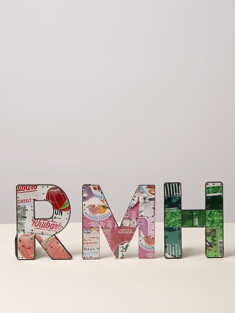 metal letters displayed on shelf made from recycled drinks cans