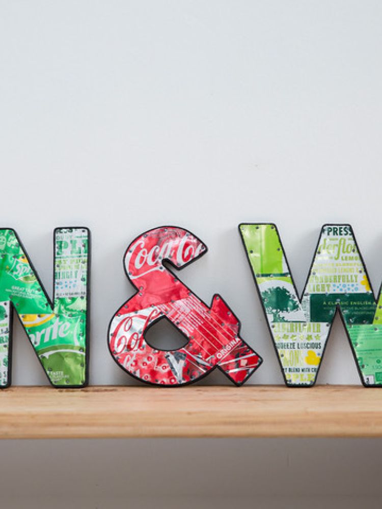 metal letters displayed on shelf made from recycled drinks cans
