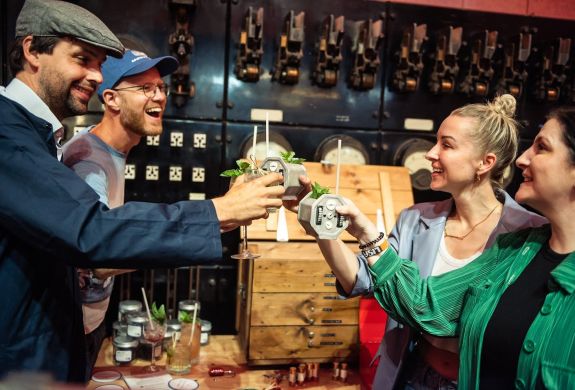 four people drinking cocktails at escape the power cut escape room