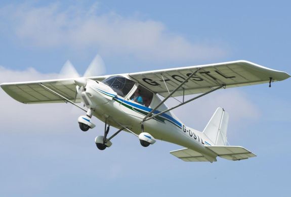 microlight in the sky flying from goodwood aerodrome