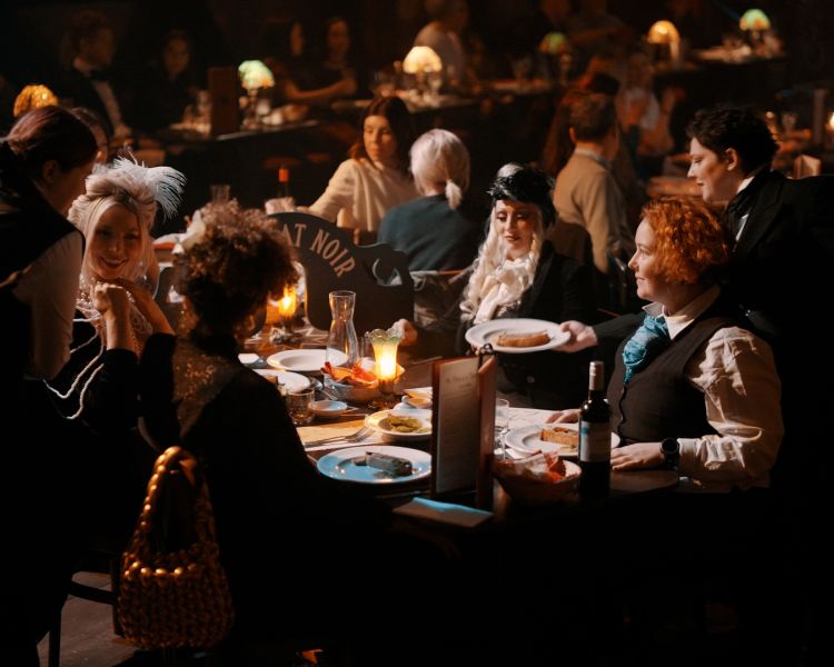 the audience at the chat noir immersive show and dining experience