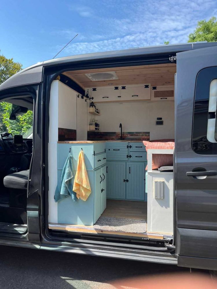 campervan with door open to see the conversion inside