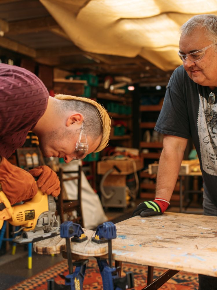 man using hand power tools in workshop on campervan conversion course