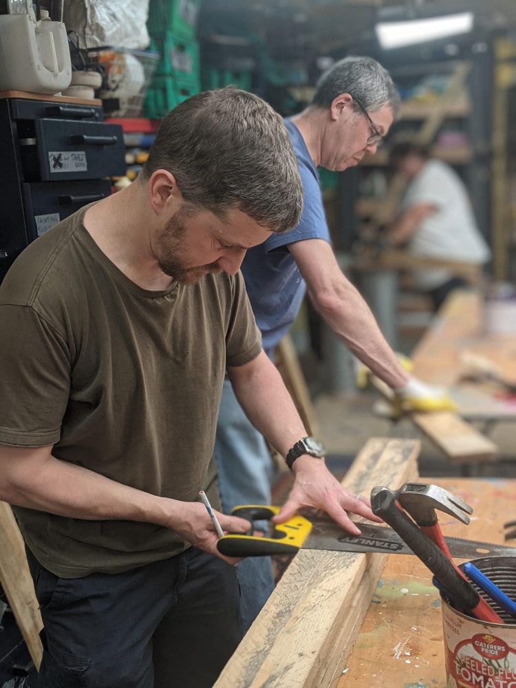 men in workshop working on campervan conversion course