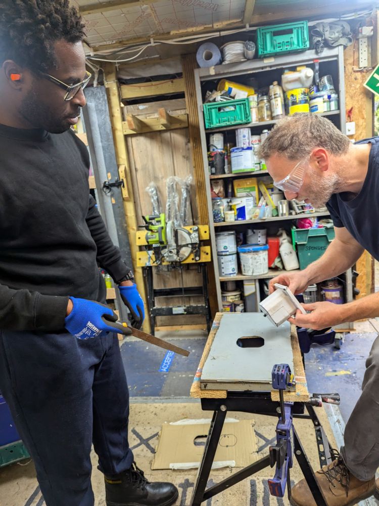 two men in workshop working on campervan conversion course
