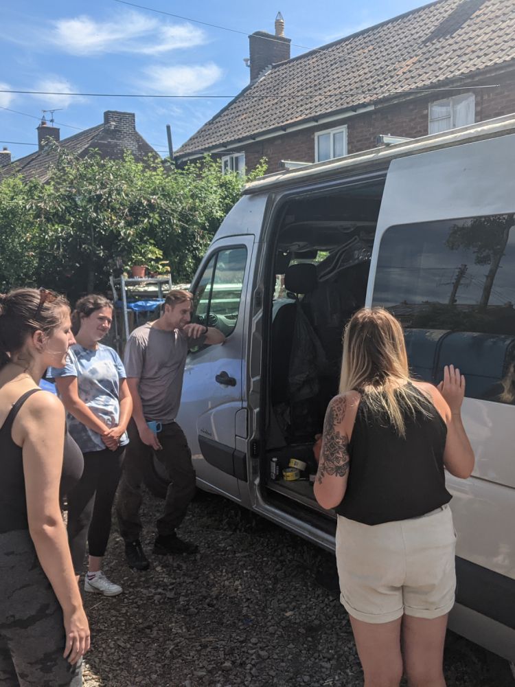 people looking inside a campervan on a campervan conversion course