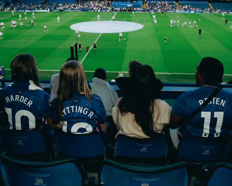Spectators in stand watching chelsea womens game at stamford bridge
