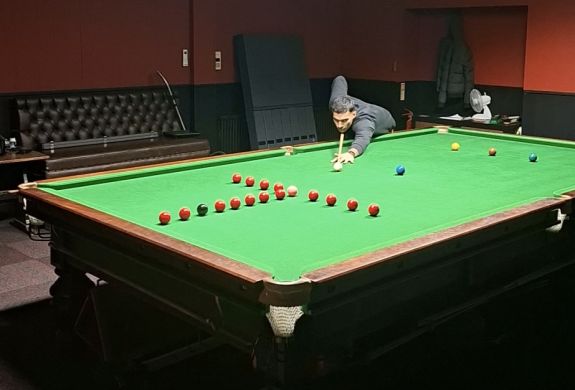 man at snooker table showing shot for snooker pool masterclass in london