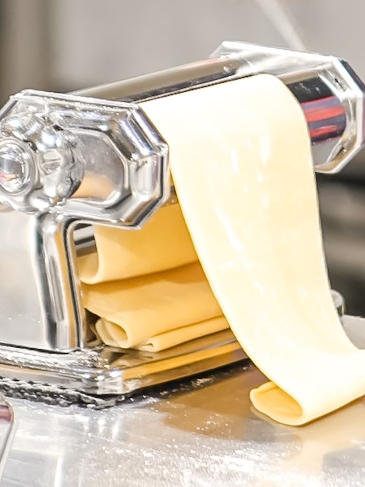 a pasta machine for rolling pasta dough used on a pasta making experience