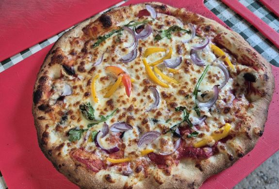 a wood-fired pizza made on a pizza making workshop