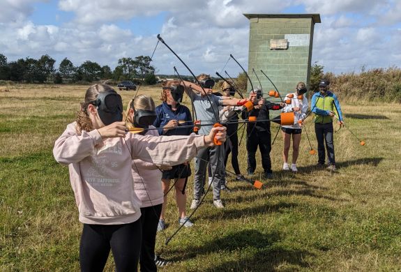 group shooting arrows on combat archery experience