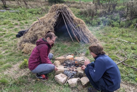 Couple next to campfire on a bushcraft experience