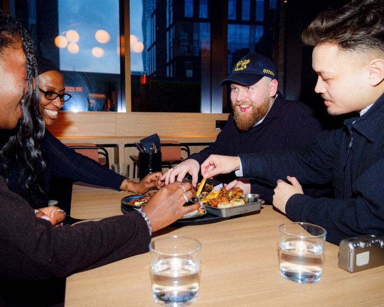 Friends tucking in to indian street food platter on a food treasure hunt in manchester