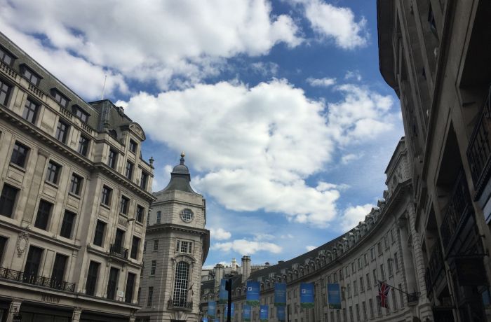 city buildings against a cloudy blue sky