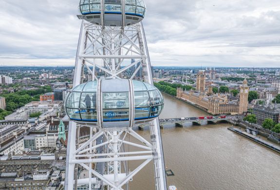 close up of pods on the london eye with london views in background