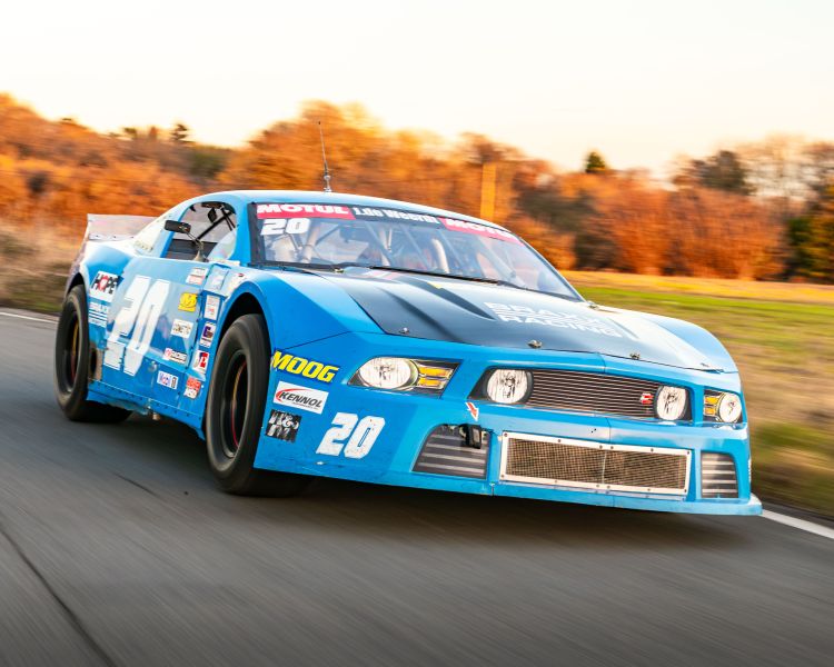 a mustang "late model nascar" on a race track at a gt race car driving experience