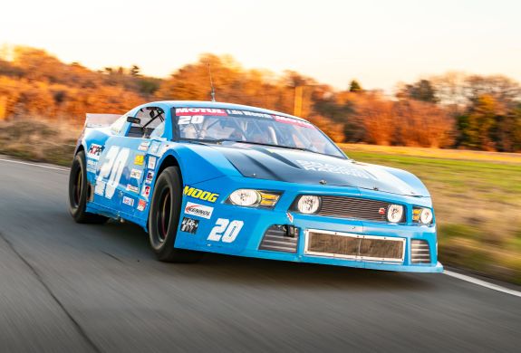 a mustang "late model nascar" on a race track at a gt race car driving experience