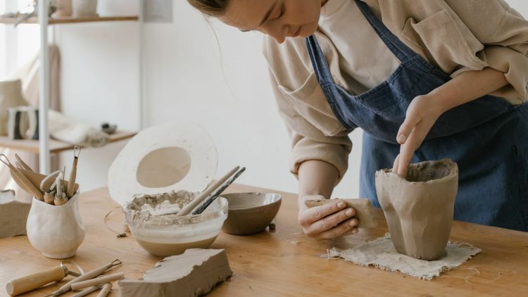 women making something out of clay on a pottery experience day