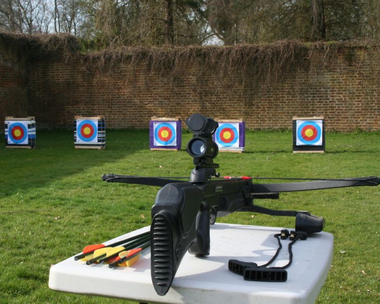 an air rifle set up on a table with five targets in the background for a spy camp experience day for adults