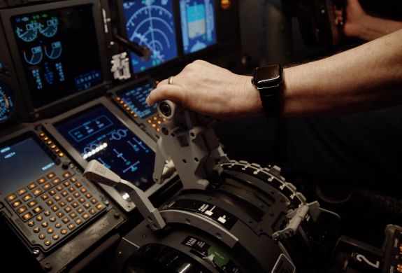 a mans hand on the controls in a plane flight simulator at deeside flight simulators