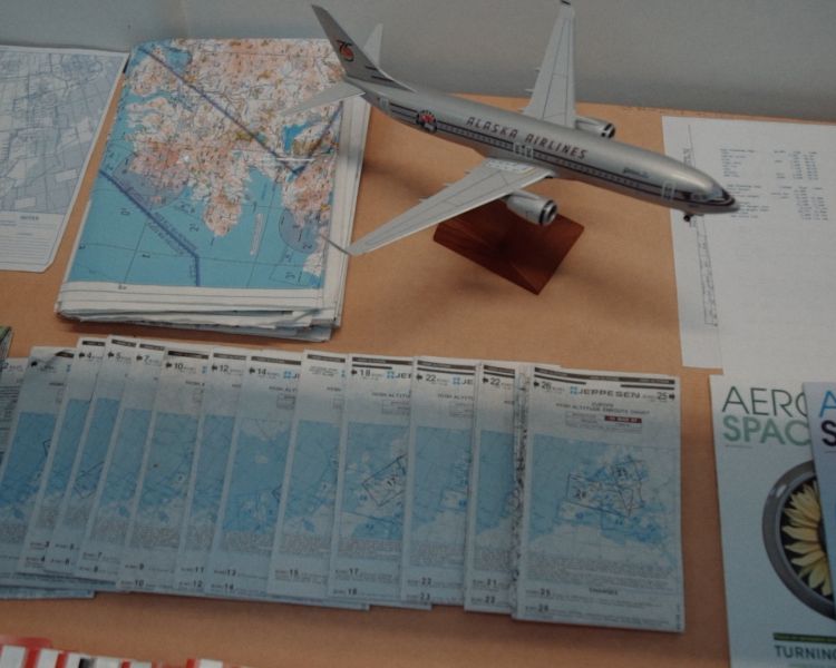 a collection of maps and model aircraft on a table seen at deeside flight simulators