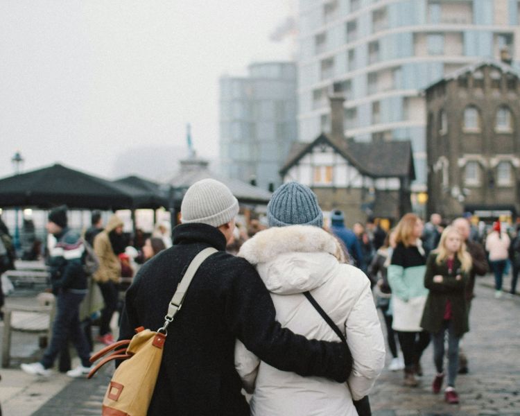 Couple walking by the tower of london in winter