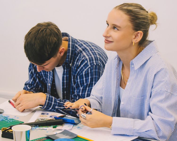 two people working at a table on their jewellery pieces during a gemstone jewellery making workshop with stööki