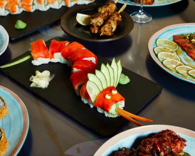 Selection of dishes on table Red Dragon Roll central compressed