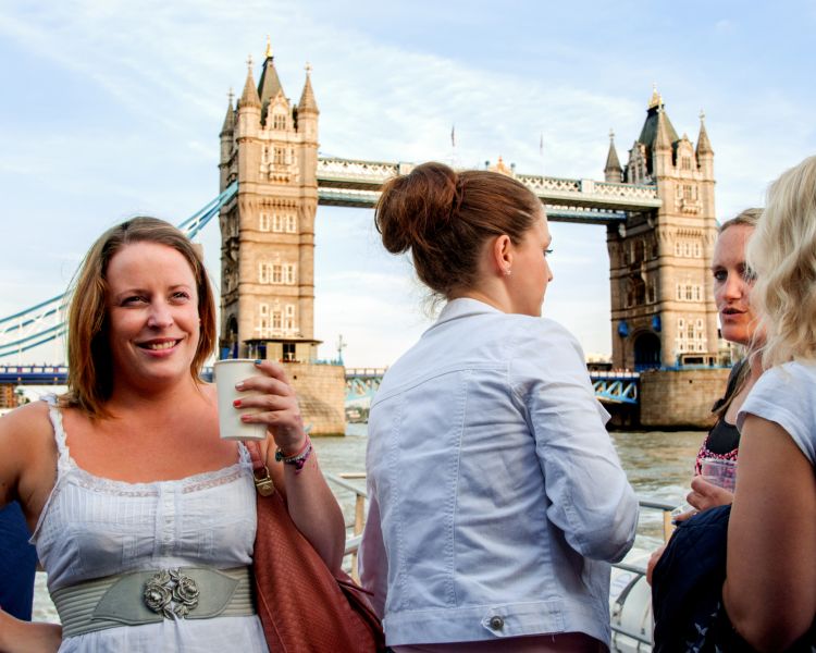 group of ladies on a thames rive cruise in front of tower bridge