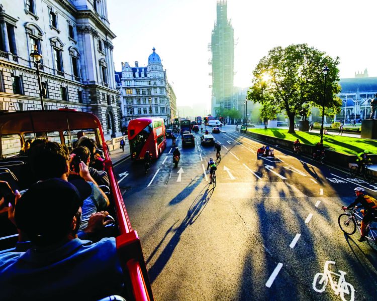 london tour bus going past westminster