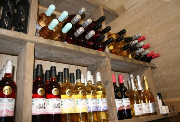 bottles of wine on shelf for a wine tasting experience in kent